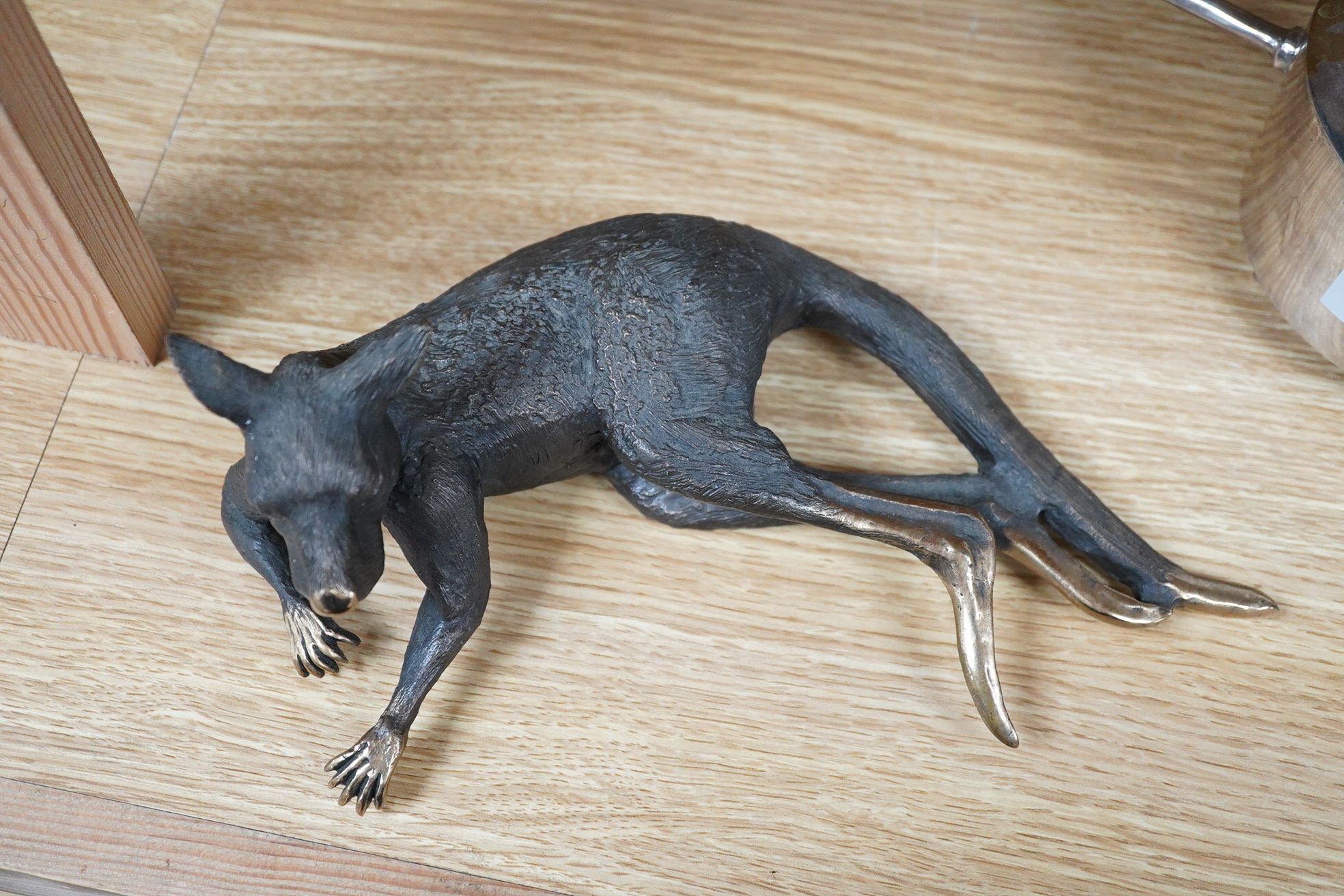 A late 20th century Australian partially gilt bronze model of a recumbent kangaroo, limited edition 5/50, 26cm wide